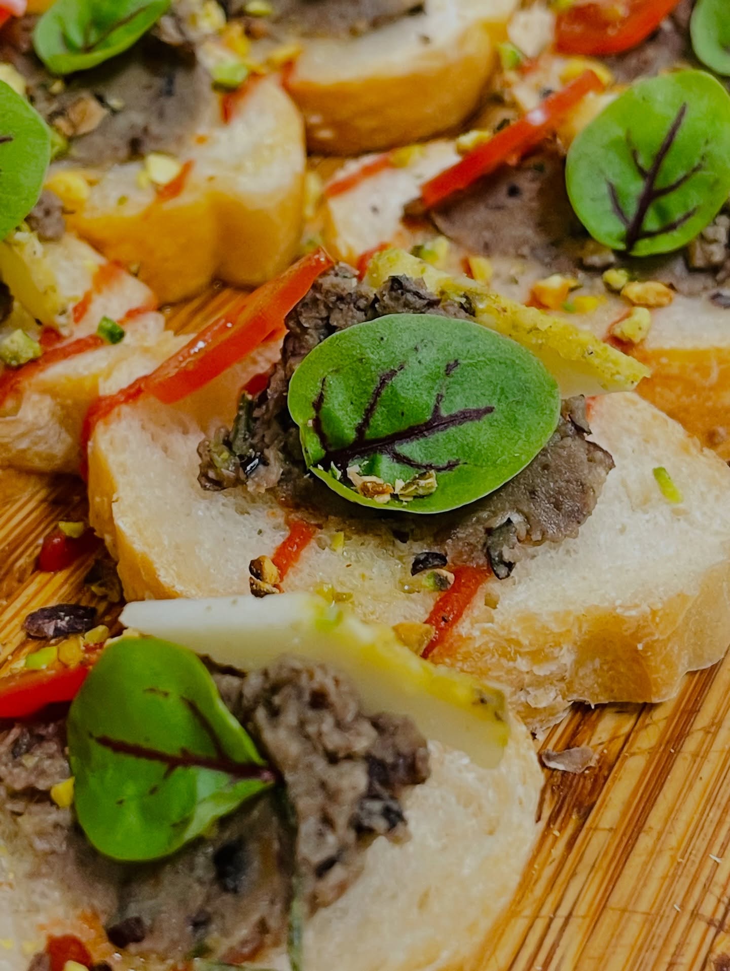 Gourmet bruschetta with tapenade, fresh herbs and pistachios