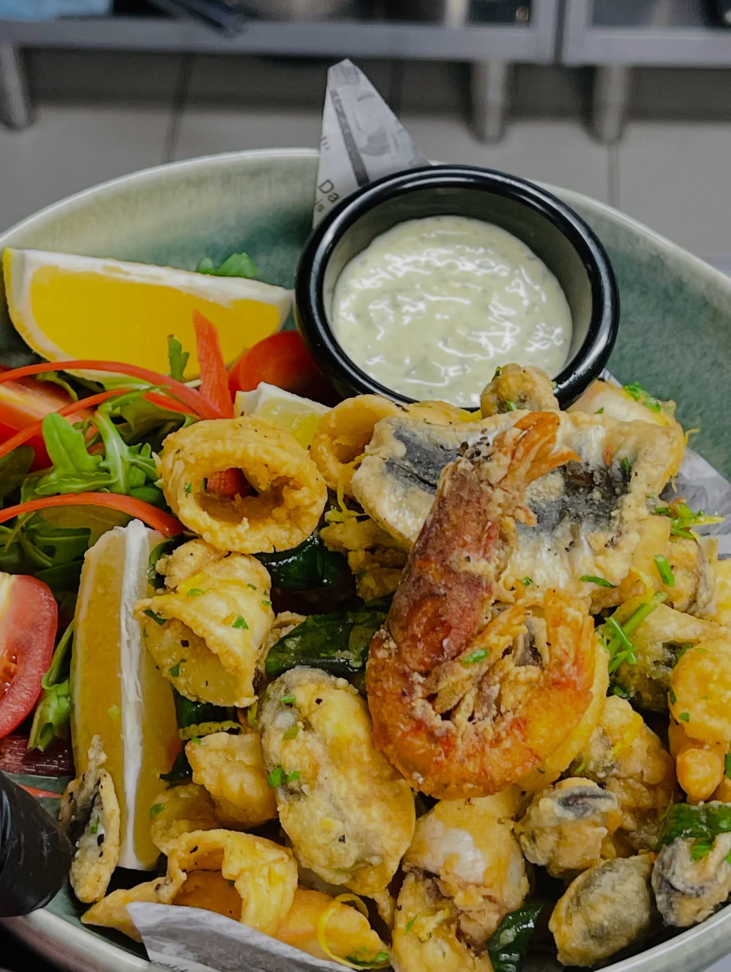 Crispy mixed fried seafood platter with tartare sauce and fresh lemon