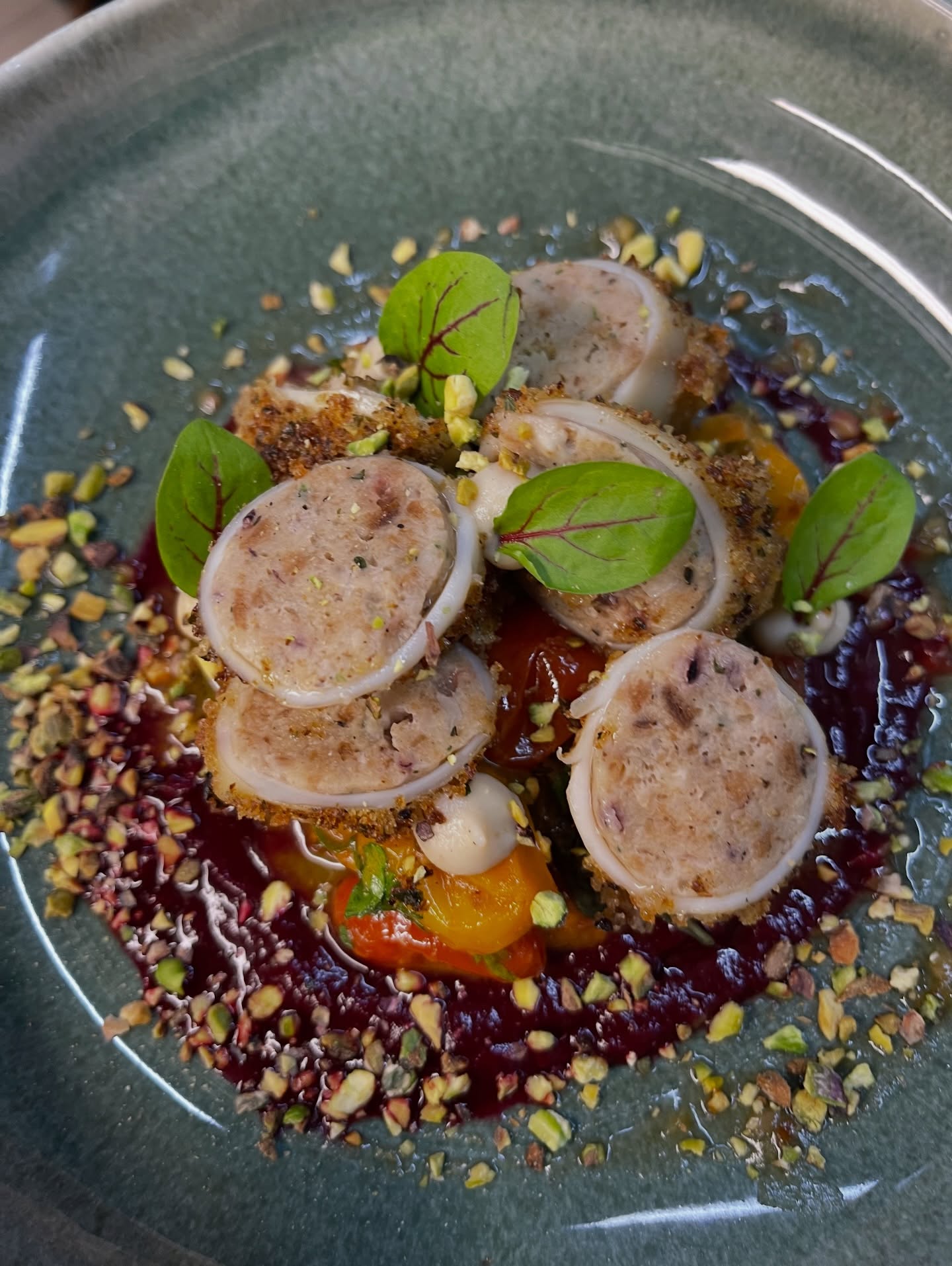 Stuffed calamari on beetroot purée with roasted peppers, crushed pistachios and red-veined sorrel